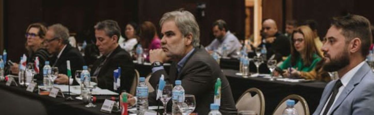 Na foto, o Diretor Presidente do DETRAN-PE, Gustavo Carneiro Leão, de perfil, com a mão esquerda no queixo e com teu cotovelo encostado na mesa. Na foto, ele está ao centro da imagem, sentado na cadeira, ao seu redor, outros Diretores Presidente dos DETRAN’s do Brasil. Essa imagem é do 74º Encontro Nacional dos Detrans, que aconteceu em Florianópolis (SC).