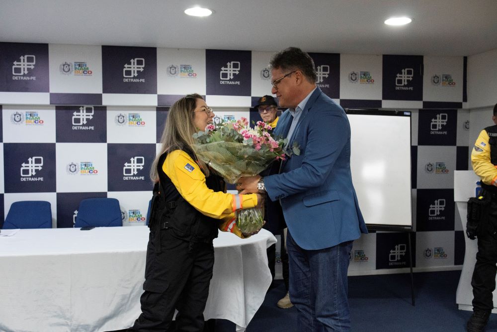 Emilia Florêncio recebendo um buquê de flores do presidente Dr. Vladimir DETRAN-PE
